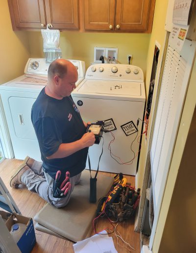 Long Electric technician using a megger to check insulation on wiring after a lightning strike hit the house!