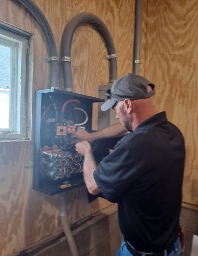 A Long Electric electrician repairing a 3 phase converter